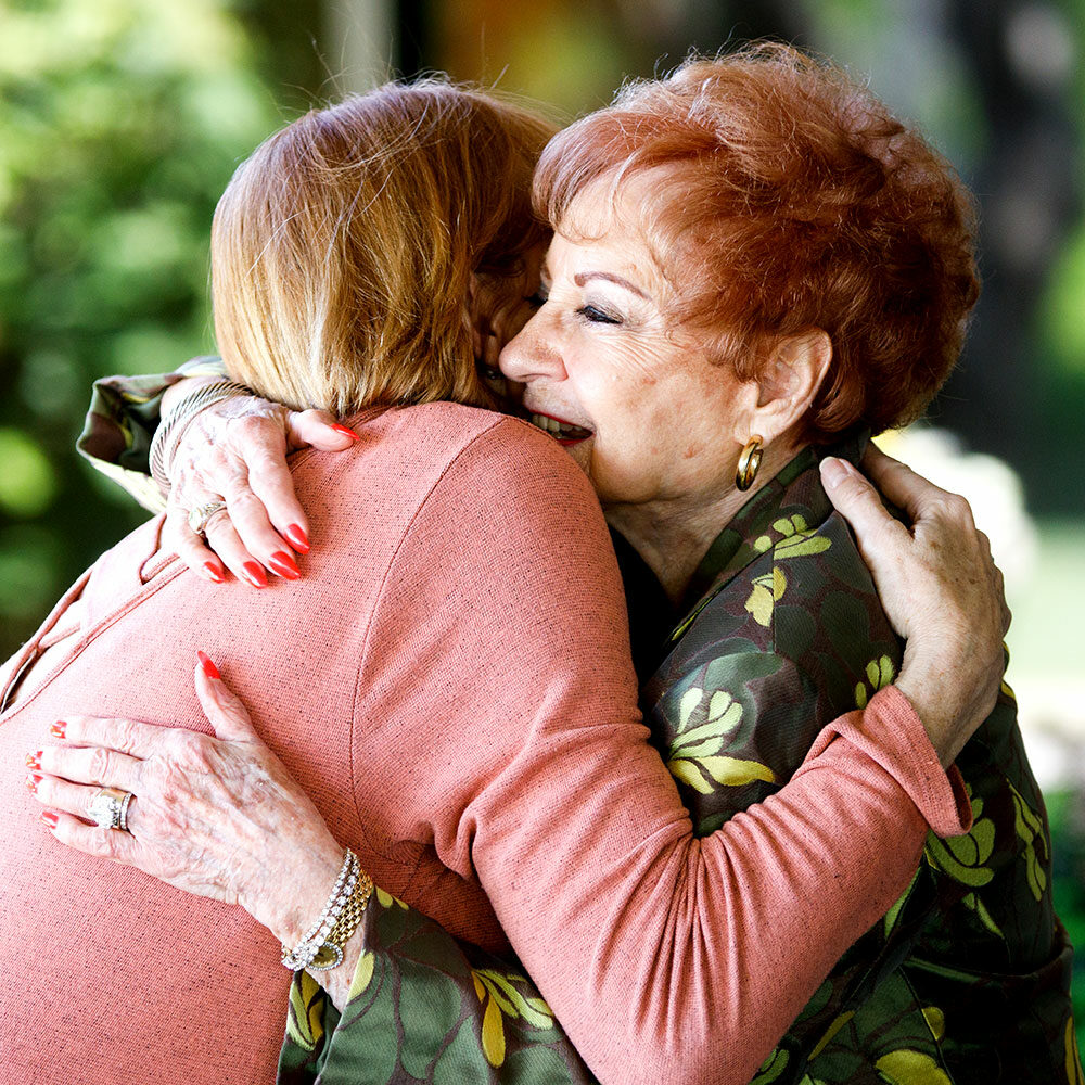 Mother and daughter hugging at Senior Living facility.